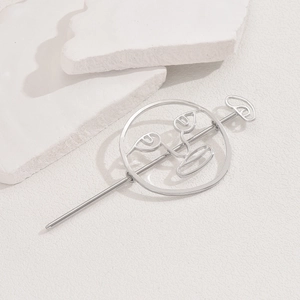 Artistic silver hollow metal hair pin with abstract human face design on white stones