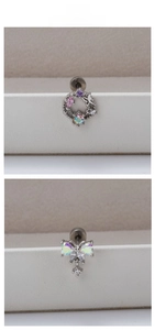 Detailed macro view of silver titanium steel earrings with iridescent zircon and butterfly
