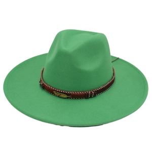 Detailed view of green wool fedora hat with brown braided band and golden feather pendant