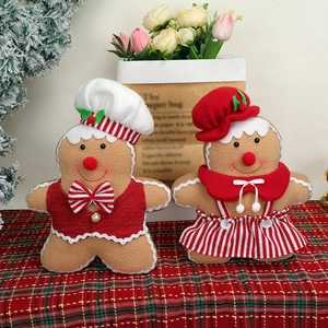 Pair of creative Christmas gingerbread man dolls in chef and skirt outfits for home decor