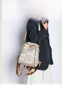 Detail of wave pattern jacquard fabric and gold zippers on a vintage style backpack