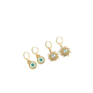 Vintage Devil's Eye gold earrings with blue eye motif and pavé crystals on white background