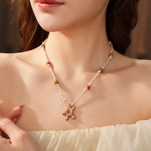 Close-up of bohemian colorful beaded necklace with a golden letter K pendant for women