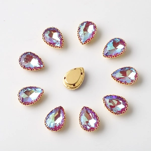 Macro shot of 10x14mm teardrop rhinestones with gold prong settings and sewing holes