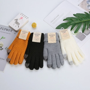 Detail of knitted winter touchscreen gloves with thick weave texture and palm grip detail