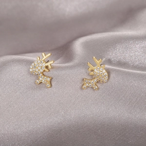 Elegant gold reindeer stud earrings with sparkling cubic zirconia on silk background