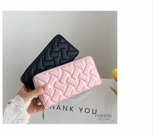 Detail of quilted lattice texture on long leather wallets in black and soft pink colors