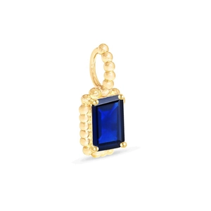 Macro detail of gold plated necklace pendant with rectangle emerald-cut blue gemstone