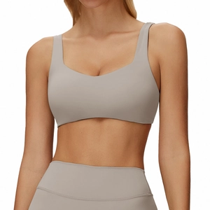 Minimalist light grey yoga bra and high waist leggings set with crisscross back design
