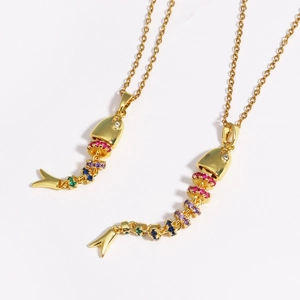 Detailed close-up of articulated golden fish pendant with vibrant multi-colored crystals
