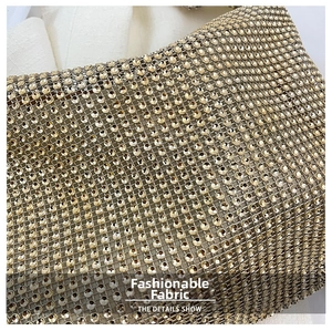Detailed close-up showing the sparkling golden rhinestone mesh fabric on the shoulder bag