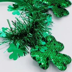 Close-up of green sequin shamrock headband with metallic fringe for St. Patrick's Day party