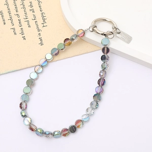 Detailed macro of iridescent crystal beaded phone charm with a silver spring clasp and tag