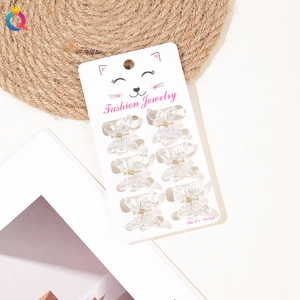 Set of six glittery butterfly hair clips displayed on a white cardboard packaging card