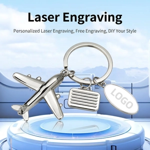 Silver jet aircraft and suitcase keychain with laser engraving on oval metal tag