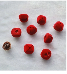 Set of eight red flocked 2.5cm Christmas bells with cross openings on white plush