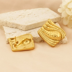 Detailed view of 18k gold plated earrings with hammered texture and wavy folds