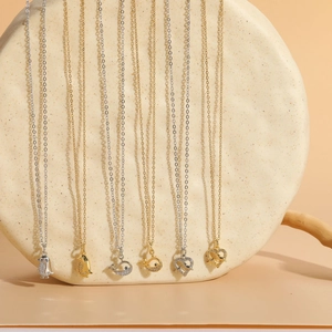 Detailed view of 14K gold plated marine series necklaces with whale and fish pendants