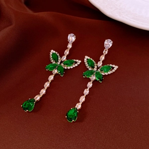 Detail of butterfly drop earrings with green teardrop crystal and sparkling zircons