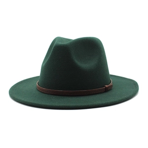 Detail of a dark green fedora hat with a thin brown leather band and metallic buckle