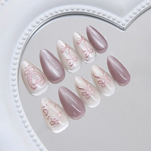 Lilac cat eye press on nails with 3D bows, heart charms, and almond shape design