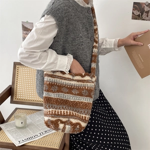 Detailed texture of plush bucket bag featuring brown and white geometric stripes