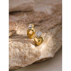 18k gold plated stainless steel heart stud earrings with white zircon on stone background