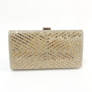 Detailed macro shot of champagne gold evening clutch with geometric crystal patterns