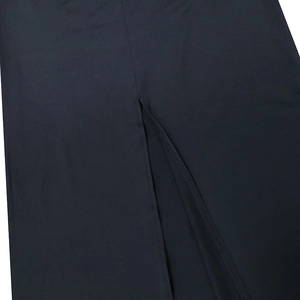 Detail view showing a high-quality slit hem and smooth fabric of this black dress