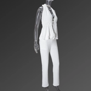 Detail of white textured fabric on backless halter top and trousers matching set