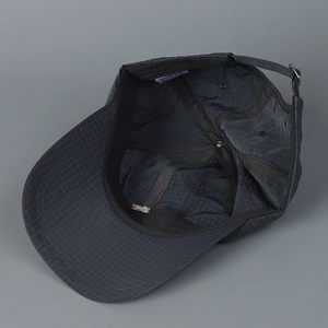 Close-up of the grey check pattern baseball cap showing interior lining and metal buckle