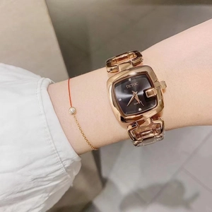 Elegant gold square watch with chain strap and black dial for women on wrist