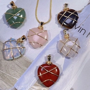 Handmade wire wrapped heart crystal pendants in various colors with a gold chain