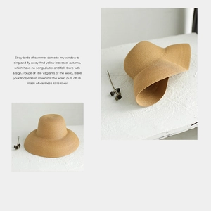 Detail of natural straw sun hat with woven texture and elegant wide brim design