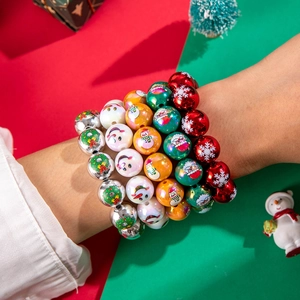 Close-up of Christmas resin beaded bracelets with snowman and bell patterns on model wrist