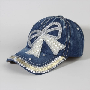 Detail of blue denim baseball cap with rhinestone bow and sparkling crystal edge