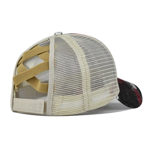 Detail of messy high ponytail criss-cross elastic bands on breathable mesh baseball cap