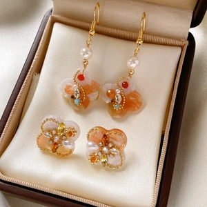 Detail of vintage flower earrings with pearls and colorful zircons in a velvet gift box