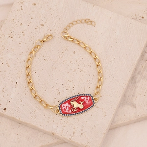 Gold chain bracelet featuring a red enamel Capricorn plaque with micro-paved blue zircons