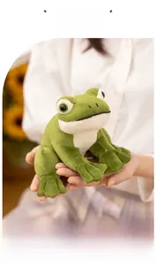 Close-up of soft green plush frog toy held by hand showing detailed fabric texture