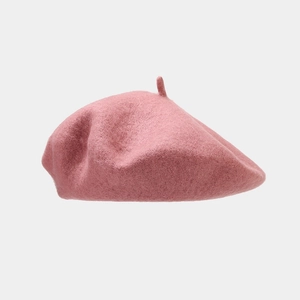 Detailed texture of pink wool beret hat showing the soft fabric and top stem detail