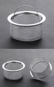 Close-up of stainless steel kitchen sink strainer basket with fine mesh and handle