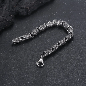 Macro shot of punk style stainless steel snake head bracelet with vintage finish and scales