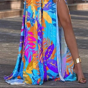 Floral leaf print maxi dress with high slit and vibrant tropical patterns for vacation