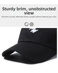 Detail of sturdy brim on black cotton baseball cap with white embroidery craftsmanship