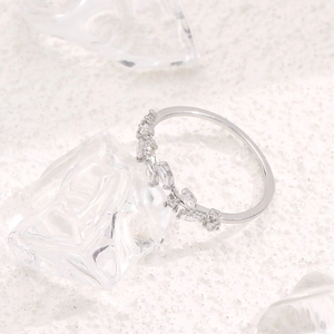 Minimalist silver leaf ring with micro-set zircon stones in an adjustable open design