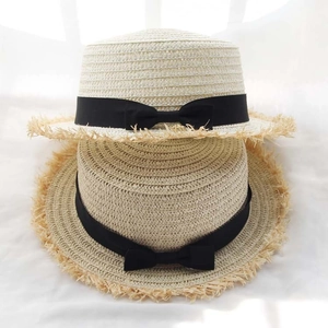 Women's Raffia straw boater hats with black ribbon bow and frayed edge detailing