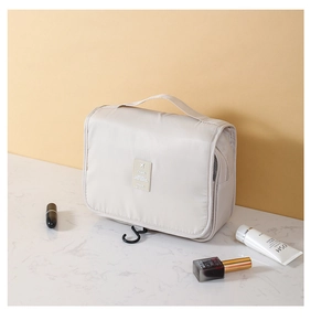 Macro detail of beige travel toiletry bag with hook and functional carrying handle