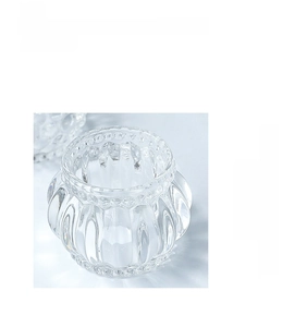 Detailed top view of a pumpkin-shaped glass candle holder with vertical ribbed texture