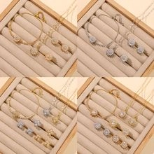 Detailed set of sunflower-shaped jewelry with gold and silver finish in a jewelry box